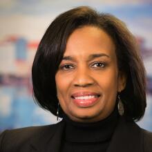 Portrait of a smiling woman in a dark blazer