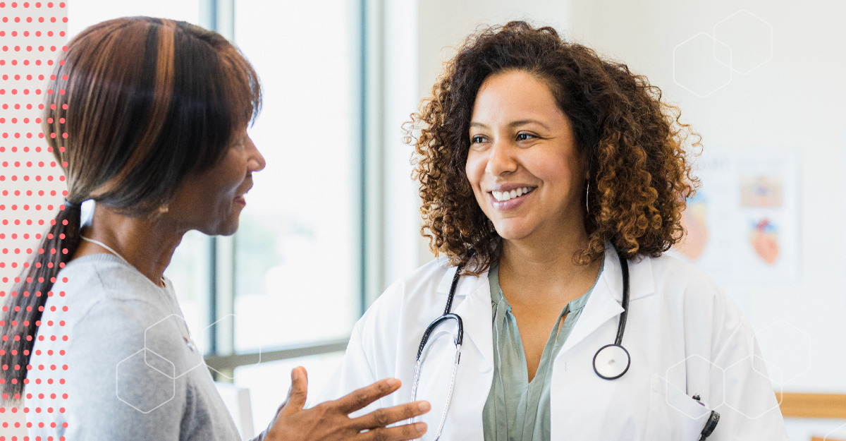 Two women of color, a patient and a doctor, having a conversation.