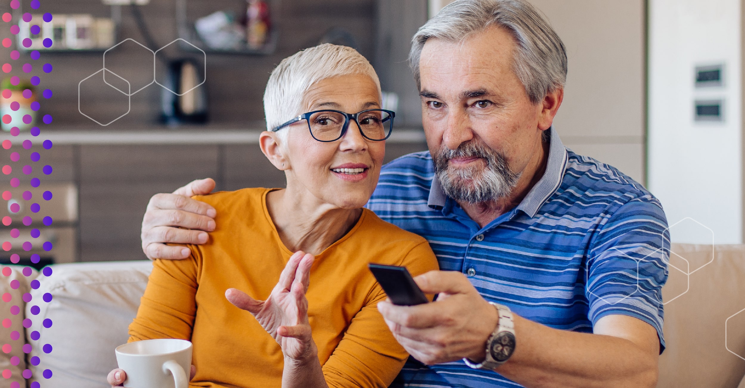An elderly couple on a couch using a TV remote control